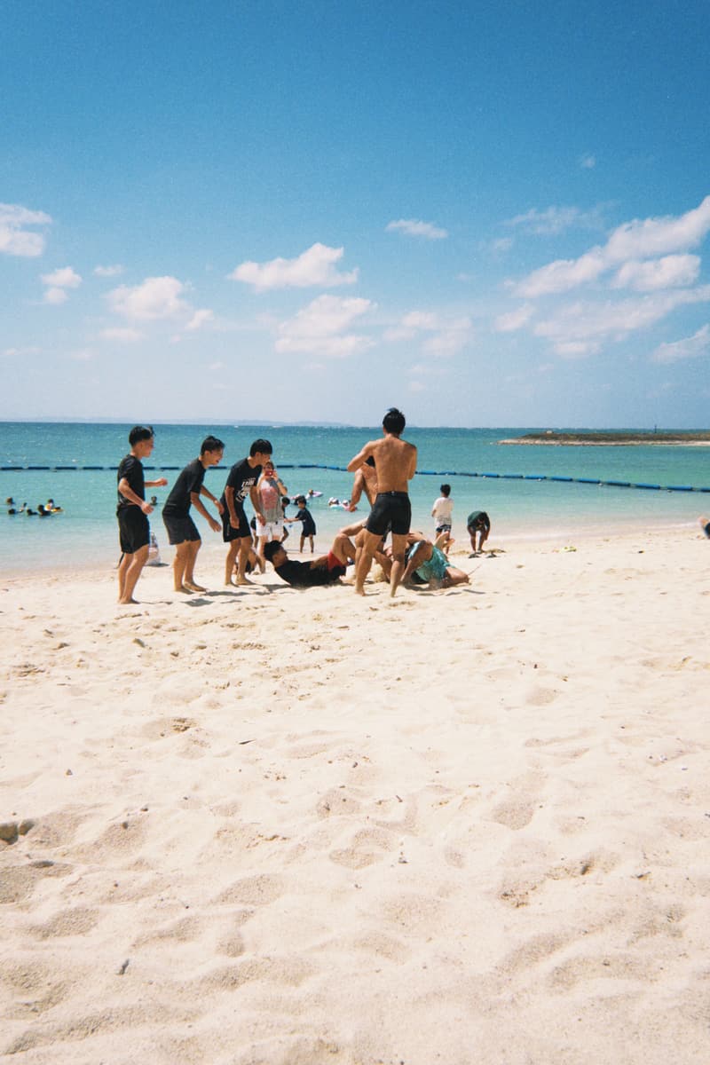 Young people playing together on a white-sand beach in Okinawa